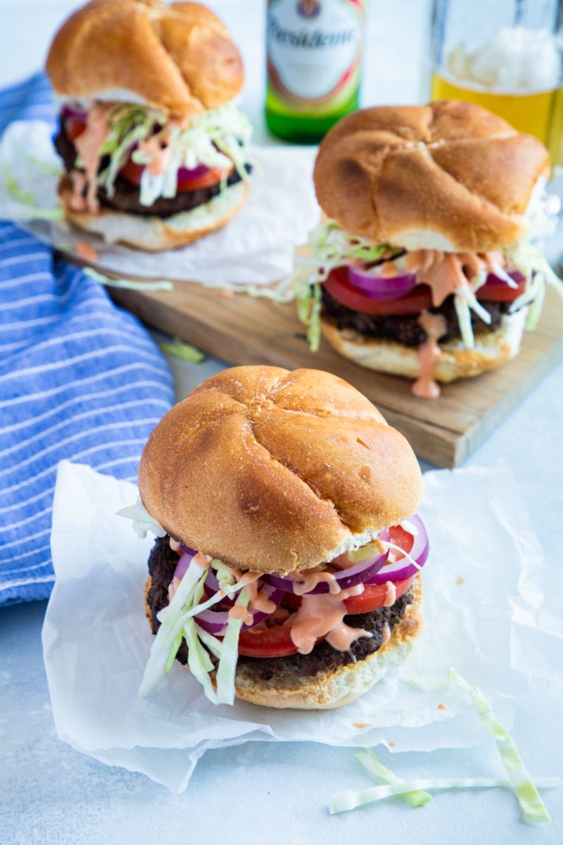 Three Dominican burgers served in buns.