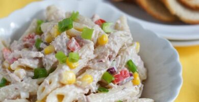 Tuna penne pasta salad served in a white bowl.